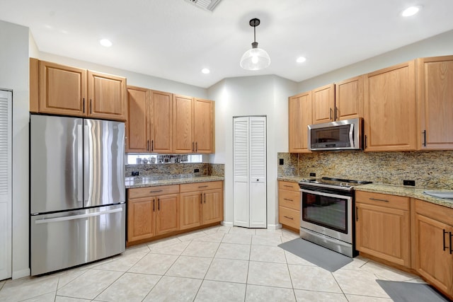 kitchen featuring pendant lighting, decorative backsplash, light stone countertops, appliances with stainless steel finishes, and light tile patterned floors