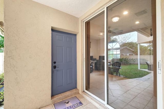 entrance to property featuring a patio