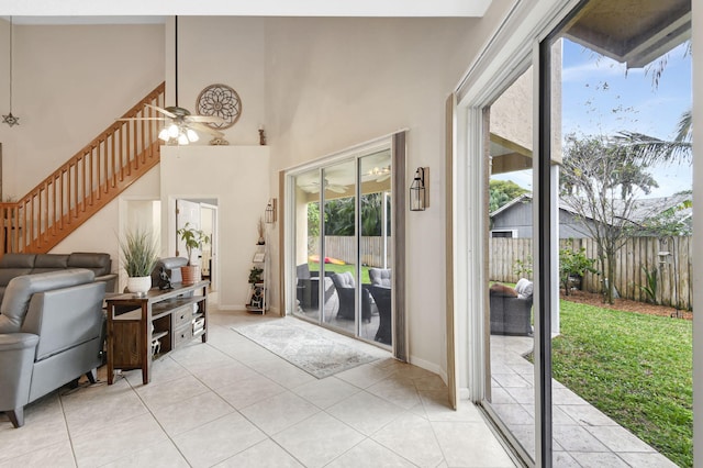 entryway with ceiling fan, light tile patterned floors, and a wealth of natural light