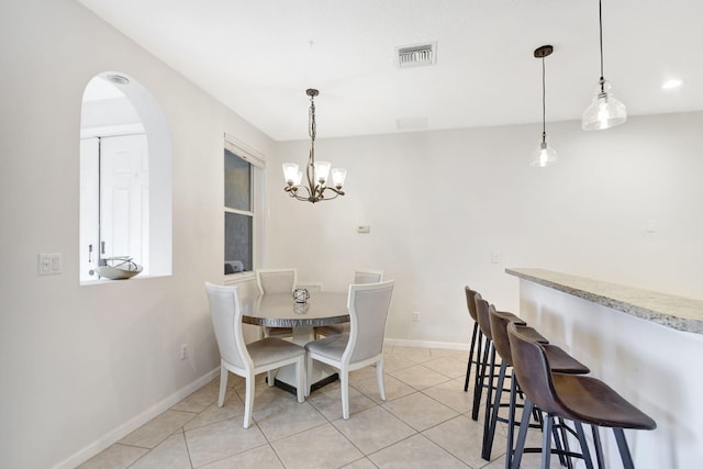 dining space featuring a notable chandelier and light tile patterned flooring