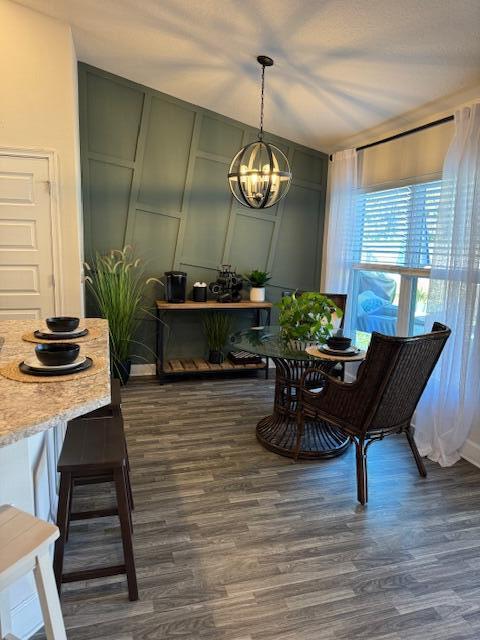 dining room featuring a chandelier and dark wood-type flooring