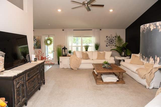 living room featuring light colored carpet, ceiling fan, and lofted ceiling