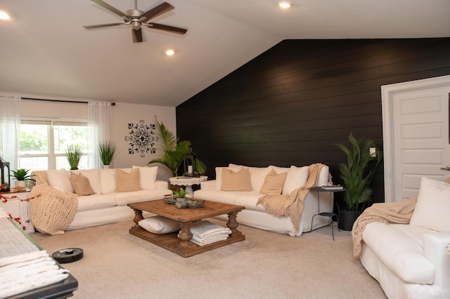 living room with light carpet, lofted ceiling, ceiling fan, and wooden walls