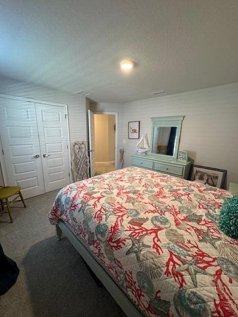 carpeted bedroom featuring a closet and a textured ceiling