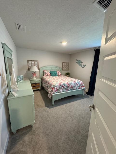 carpeted bedroom with a textured ceiling