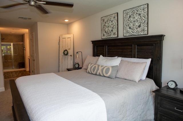 carpeted bedroom with ensuite bathroom and ceiling fan