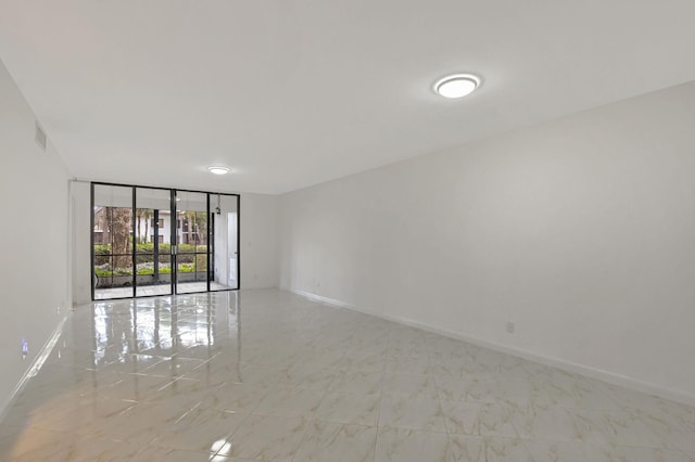 empty room with expansive windows and french doors