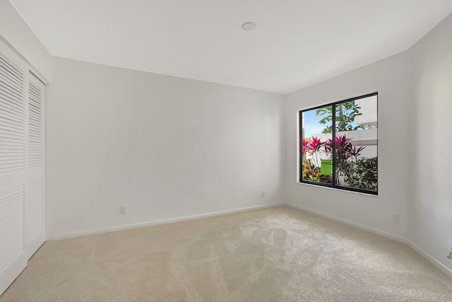 empty room featuring light carpet