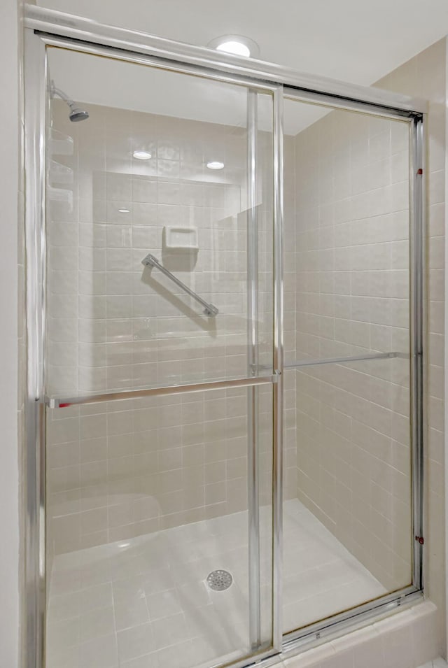 bathroom featuring a shower with shower door