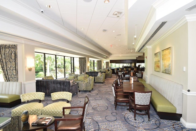 carpeted dining space featuring ornamental molding