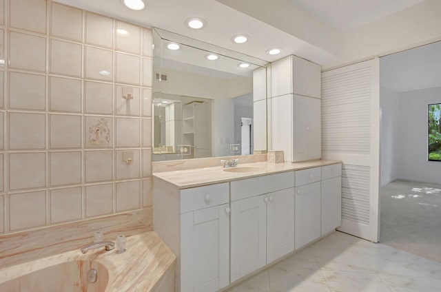 bathroom with vanity and a washtub