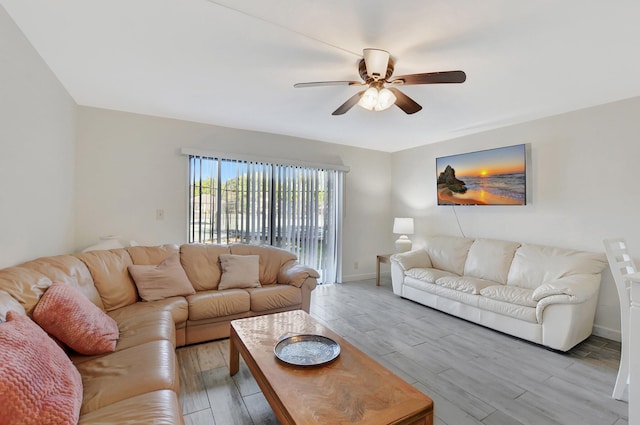 living room with ceiling fan and light hardwood / wood-style flooring