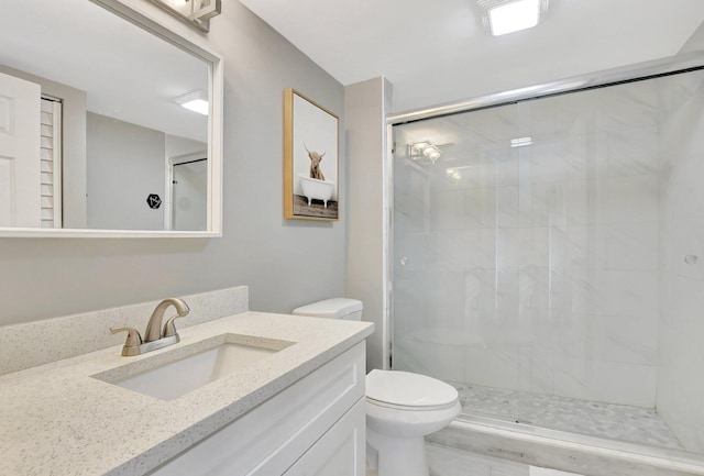 bathroom featuring vanity, toilet, and walk in shower