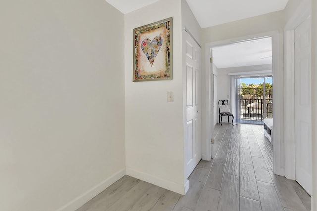 hallway with light hardwood / wood-style flooring