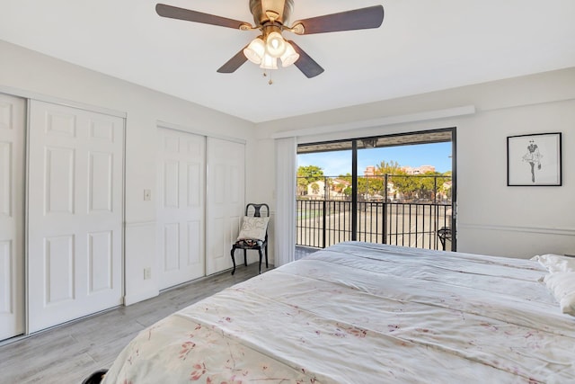 bedroom with access to exterior, ceiling fan, two closets, and light wood-type flooring