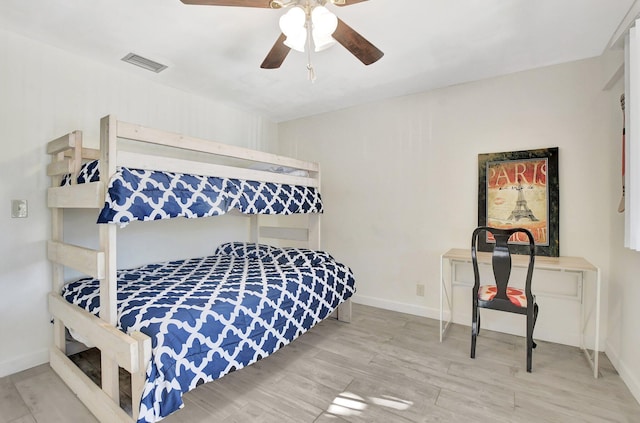 bedroom with light hardwood / wood-style flooring and ceiling fan