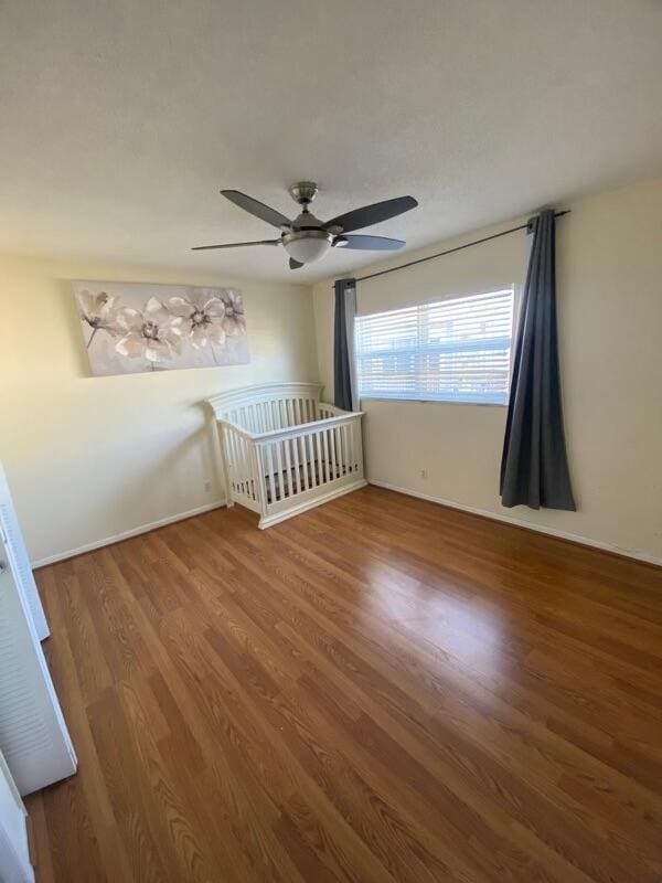 spare room with ceiling fan and hardwood / wood-style floors