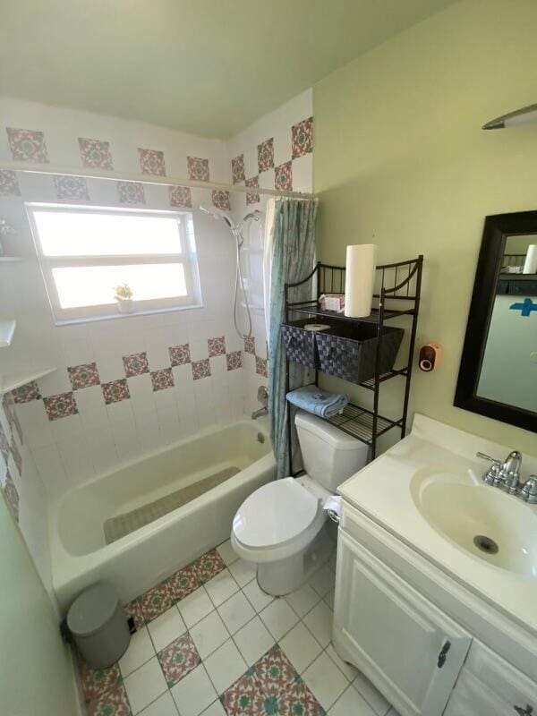 full bathroom with tile patterned floors, shower / bath combo, toilet, and vanity