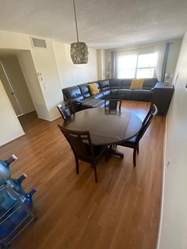 living room featuring a textured ceiling and hardwood / wood-style flooring