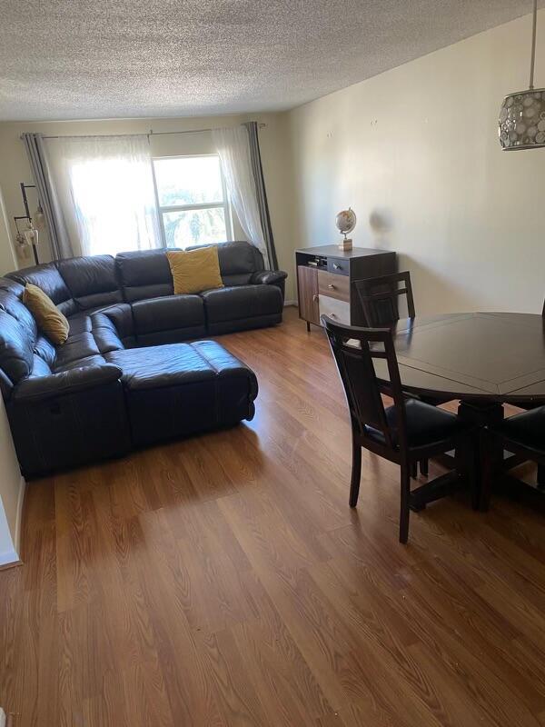 living room featuring hardwood / wood-style floors and a textured ceiling