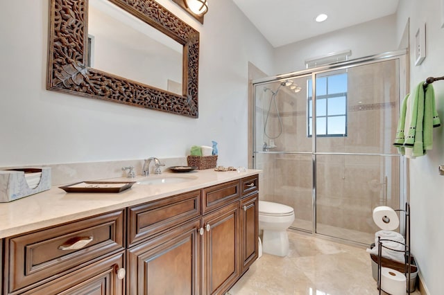 bathroom featuring walk in shower, vanity, and toilet