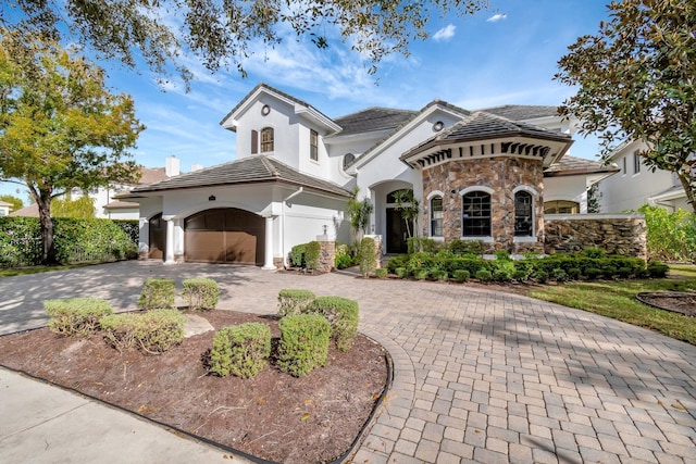 mediterranean / spanish-style house featuring a garage