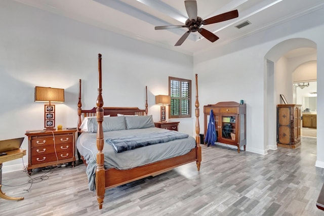 bedroom with light hardwood / wood-style flooring, ensuite bath, ceiling fan, and crown molding