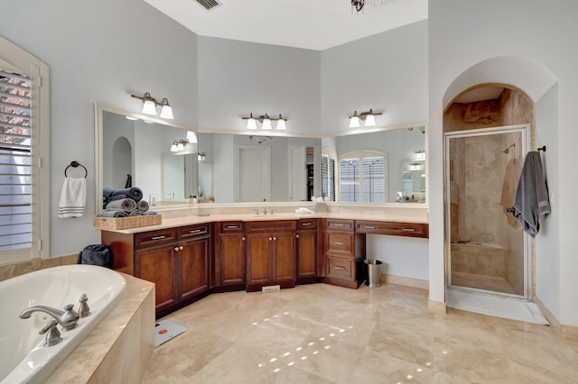 bathroom featuring vanity and separate shower and tub