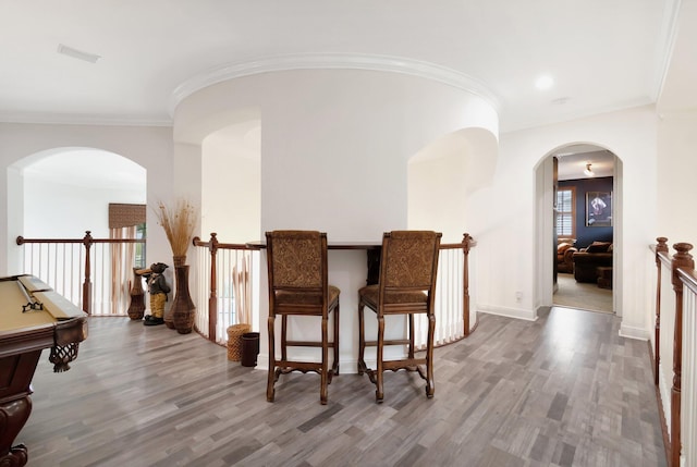 interior space featuring hardwood / wood-style flooring, ornamental molding, and pool table