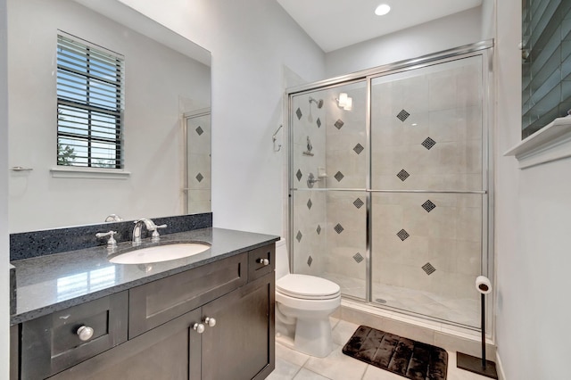 bathroom with tile patterned floors, toilet, and walk in shower