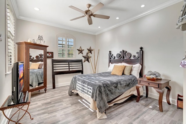 bedroom featuring ceiling fan, light wood-type flooring, and ornamental molding