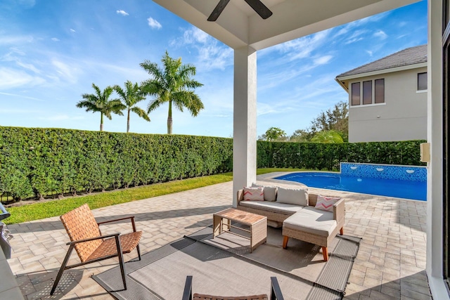 view of patio / terrace with a fenced in pool, outdoor lounge area, and ceiling fan