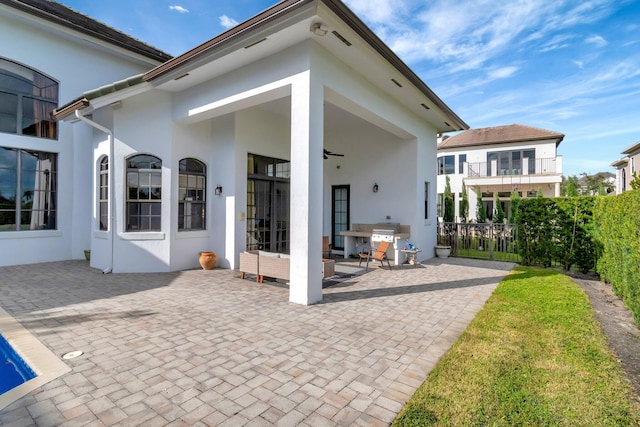 rear view of house with a patio and ceiling fan