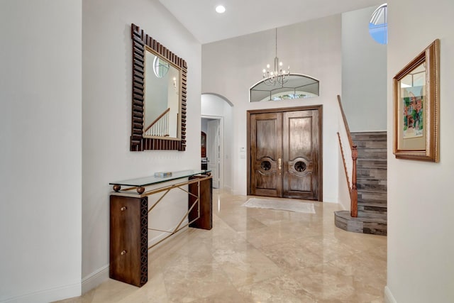 foyer entrance featuring a high ceiling and an inviting chandelier