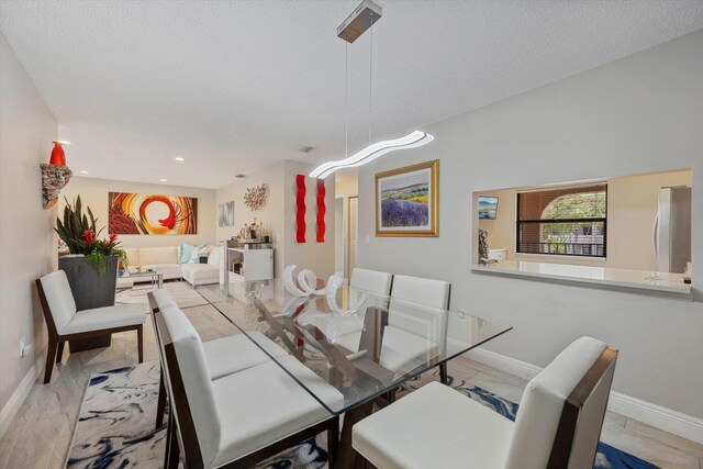 kitchen with tasteful backsplash, white cabinetry, sink, stainless steel appliances, and a textured ceiling