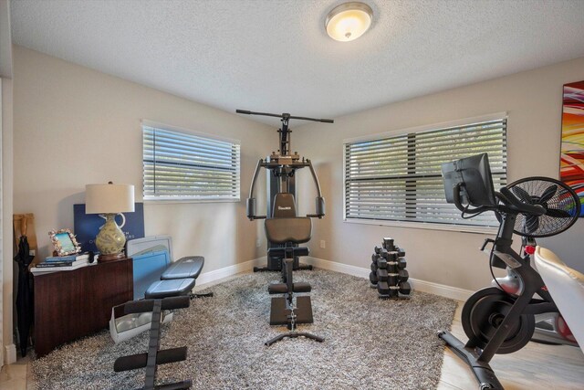 workout area with a textured ceiling