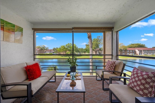 sunroom / solarium featuring a water view