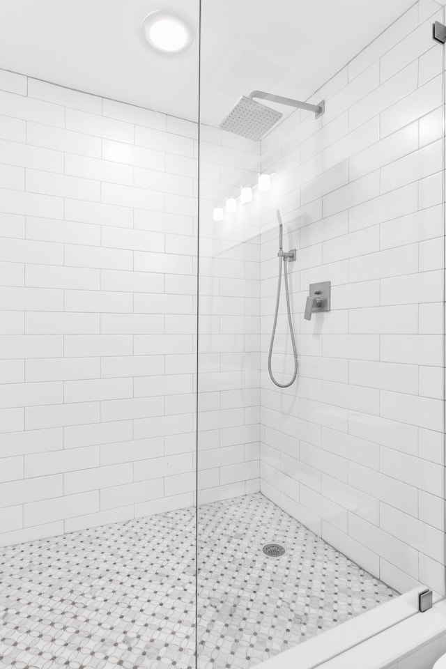 bathroom with tiled shower