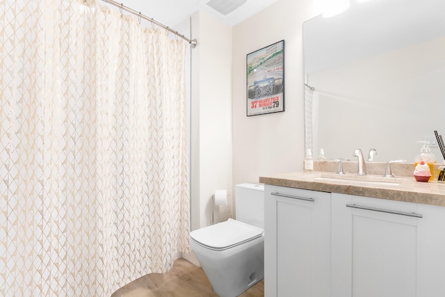 bathroom featuring toilet and vanity