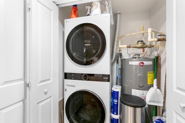 washroom featuring electric water heater and stacked washer and clothes dryer