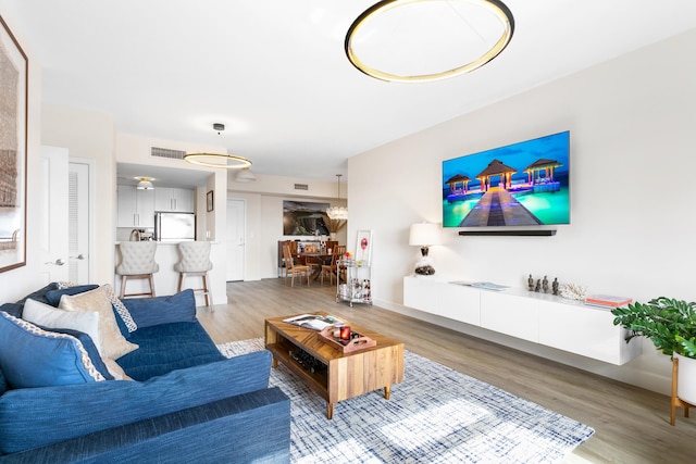 living room featuring ceiling fan and wood-type flooring