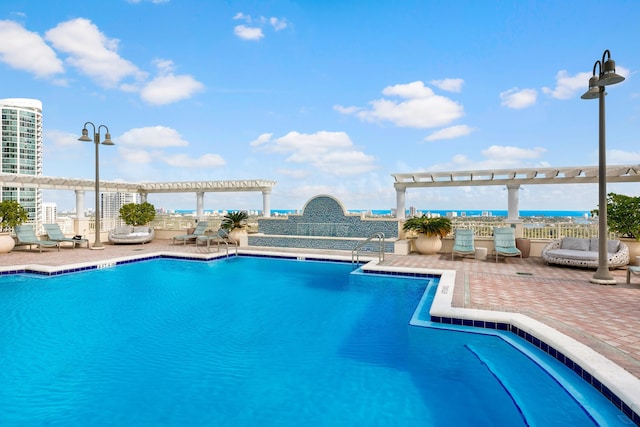 view of pool with a pergola and a patio