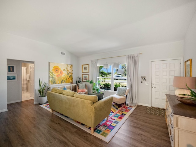 living room with dark hardwood / wood-style floors and vaulted ceiling