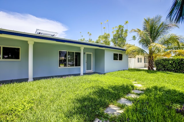 rear view of property with a lawn