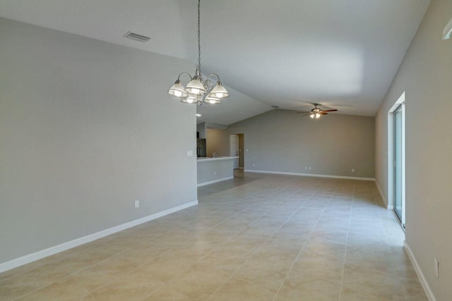 empty room with ceiling fan with notable chandelier, light tile patterned floors, and vaulted ceiling