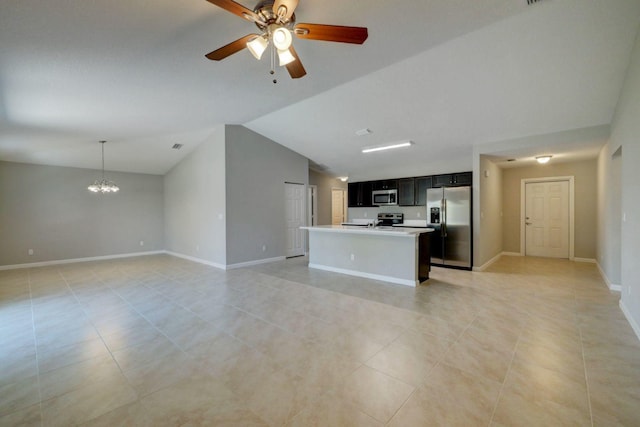 unfurnished living room with ceiling fan with notable chandelier, light tile patterned flooring, and vaulted ceiling