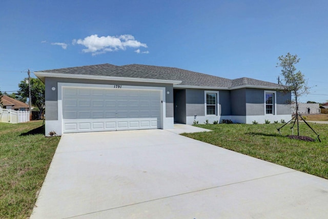 single story home with a garage and a front lawn