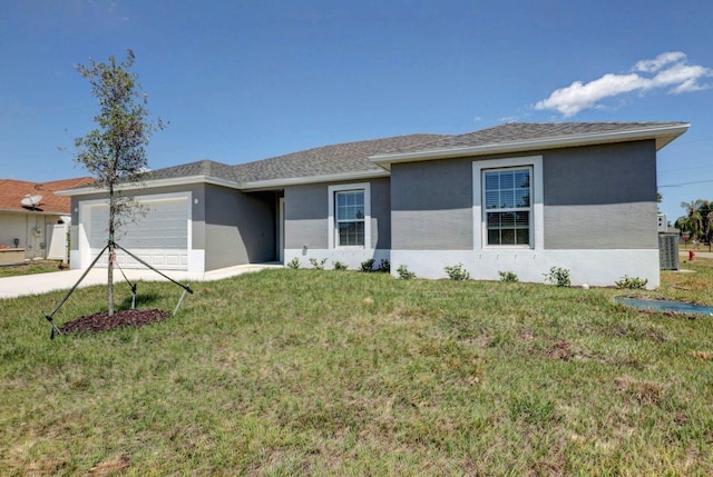 ranch-style house featuring a garage and a front lawn