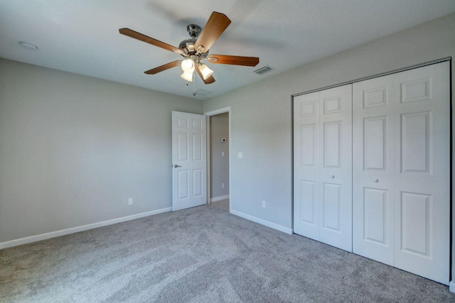 unfurnished bedroom with carpet, ceiling fan, and a closet