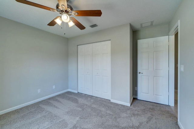 unfurnished bedroom featuring ceiling fan, light carpet, and a closet